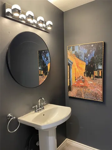 a bathroom with a sink mirror and vanity
