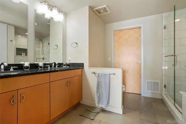 a bathroom with a glass shower door