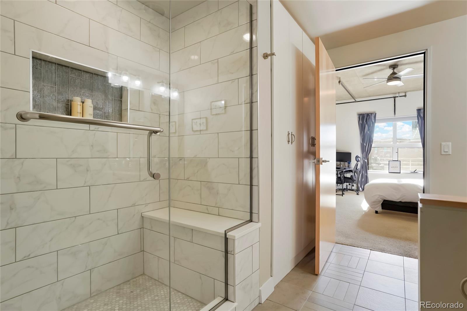 2229 Blake Street, Unit 505 Denver, CO 80205 - Photo 12 of 28 a bathroom with a glass shower door