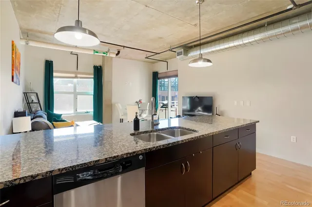 a kitchen with stainless steel appliances a stove a sink and a refrigerator