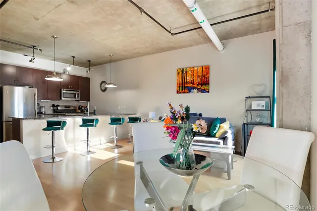 a dining room with furniture and a kitchen view