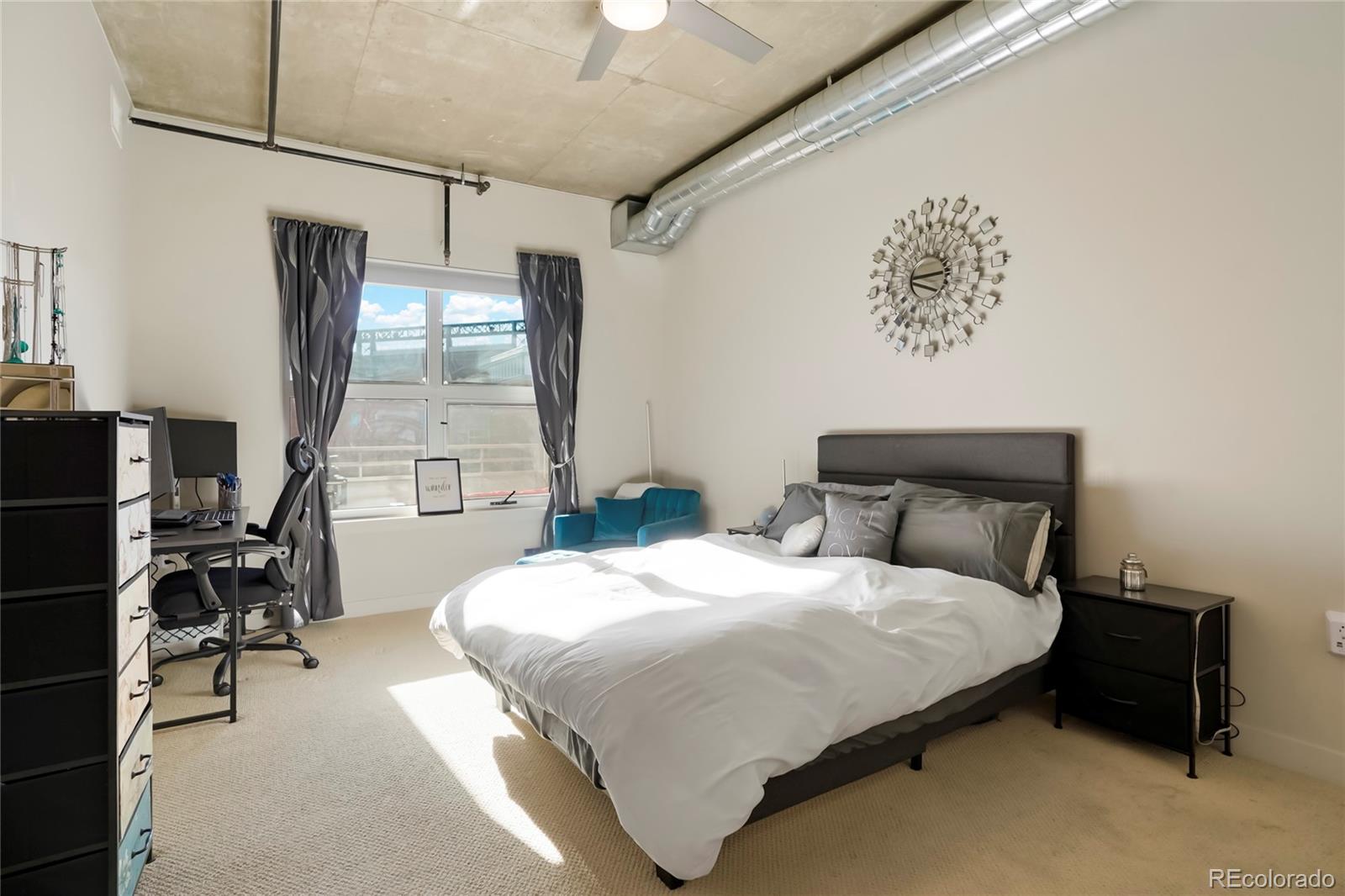 2229 Blake Street, Unit 505 Denver, CO 80205 - Photo 10 of 28 a bedroom with a bed wooden floor and a desk