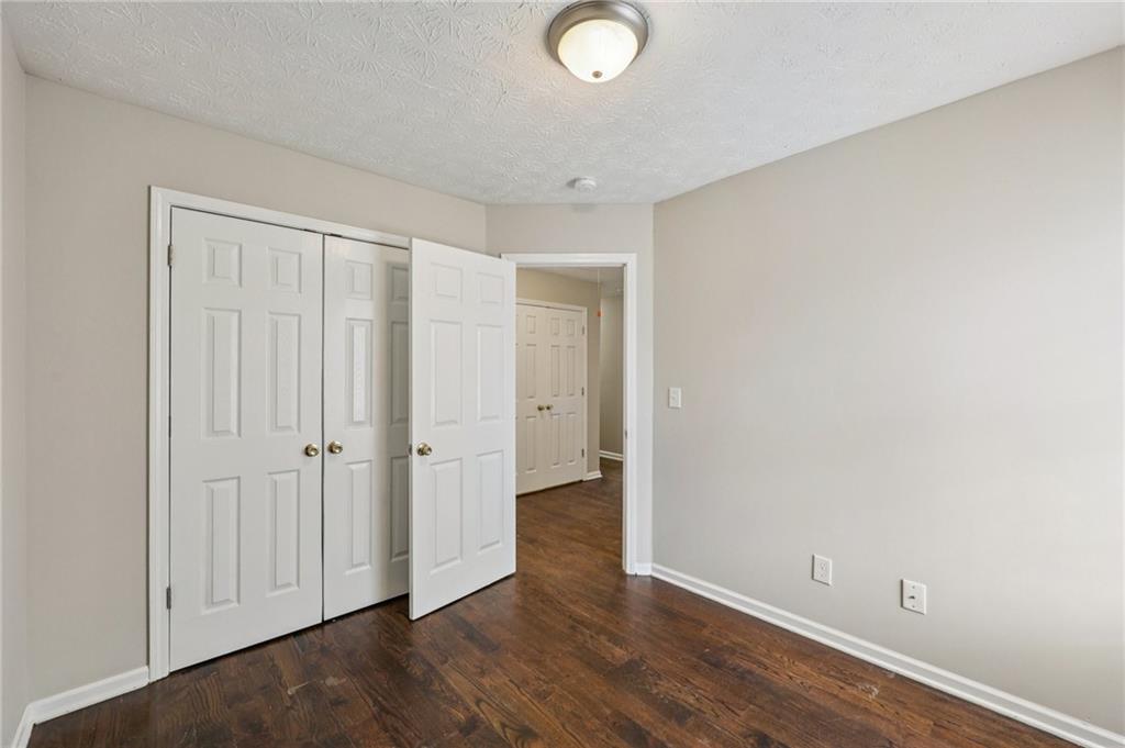 122 Nowell Street Monroe, GA 30655 - Photo 17 of 24 a view of an empty room with wooden floor