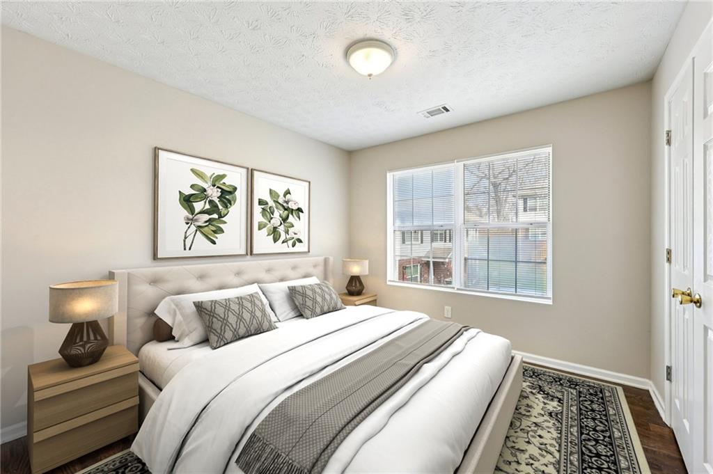 122 Nowell Street Monroe, GA 30655 - Photo 19 of 24 a bedroom with a bed and a window with chair