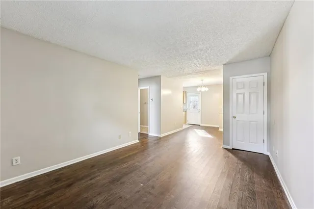 a view of an empty room and wooden floor
