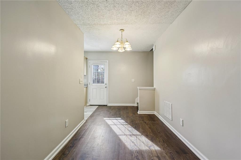 122 Nowell Street Monroe, GA 30655 - Photo 5 of 24 wooden floor in an empty room with a window