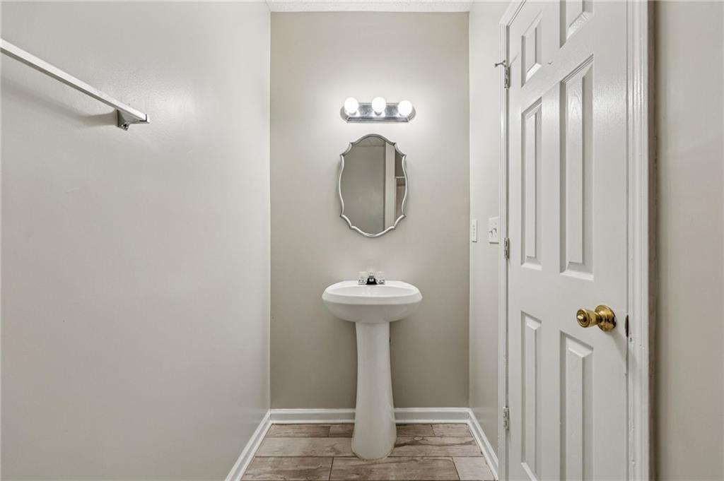 122 Nowell Street Monroe, GA 30655 - Photo 8 of 24 a bathroom with a sink a mirror and shower