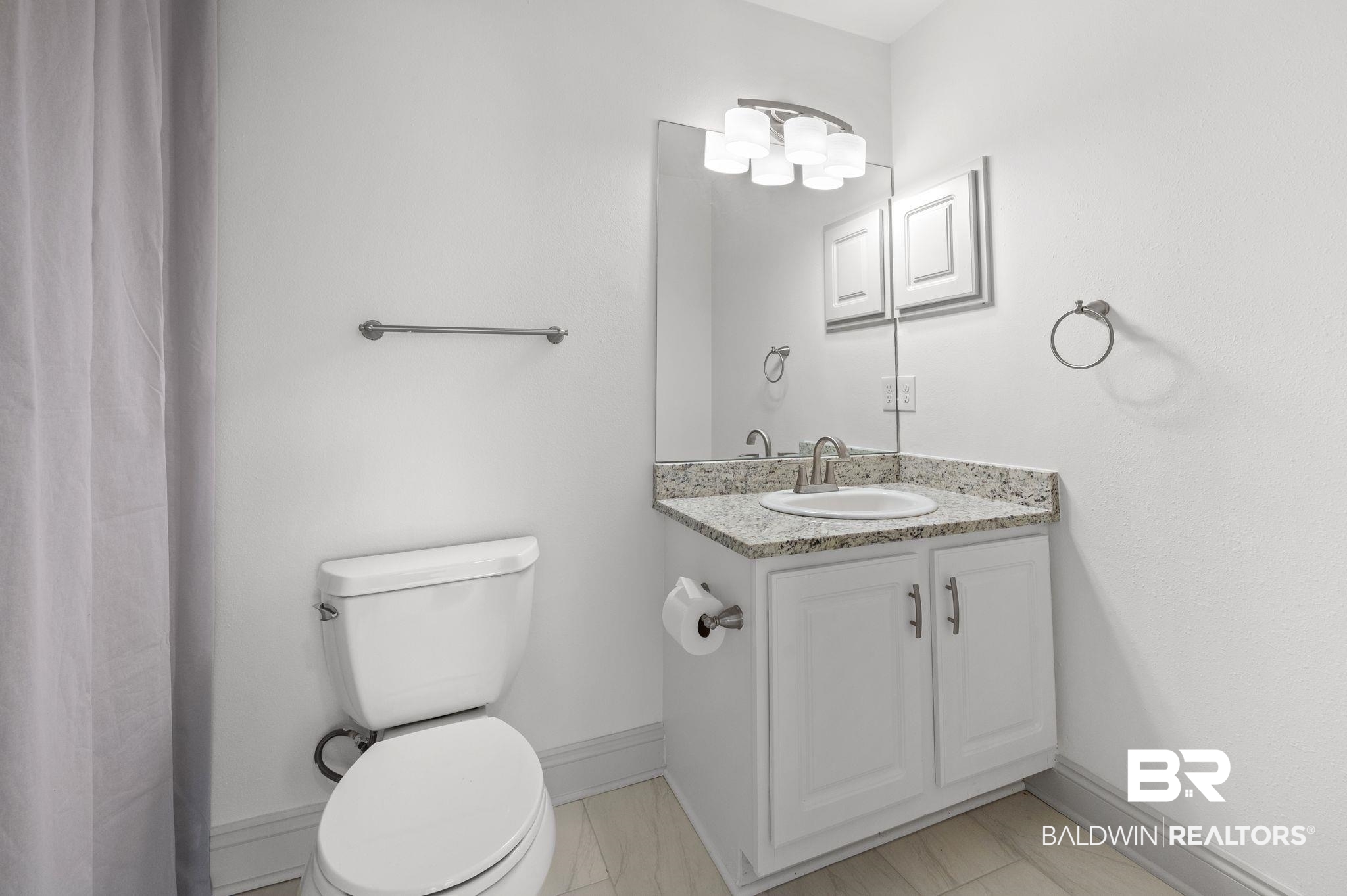 136 Destrehan Road Fairhope, AL 36532 - Photo 20 of 44 Bathroom with tile patterned flooring, toilet, and vanity