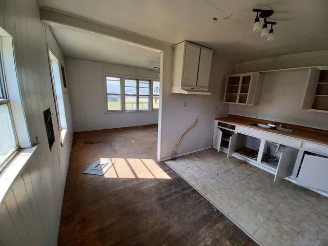 a view of a livingroom with furniture and staircase