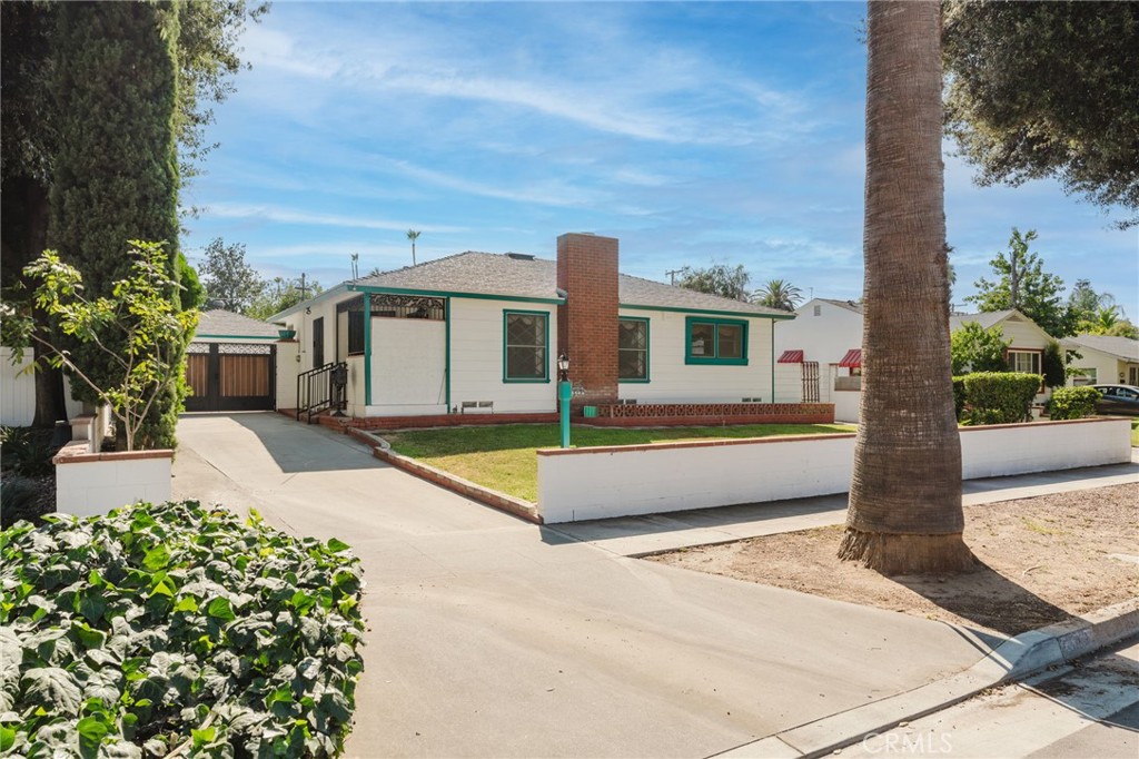 3548 Roslyn Street Riverside, CA 92504 - Photo 1 of 1 a front view of a house with a yard