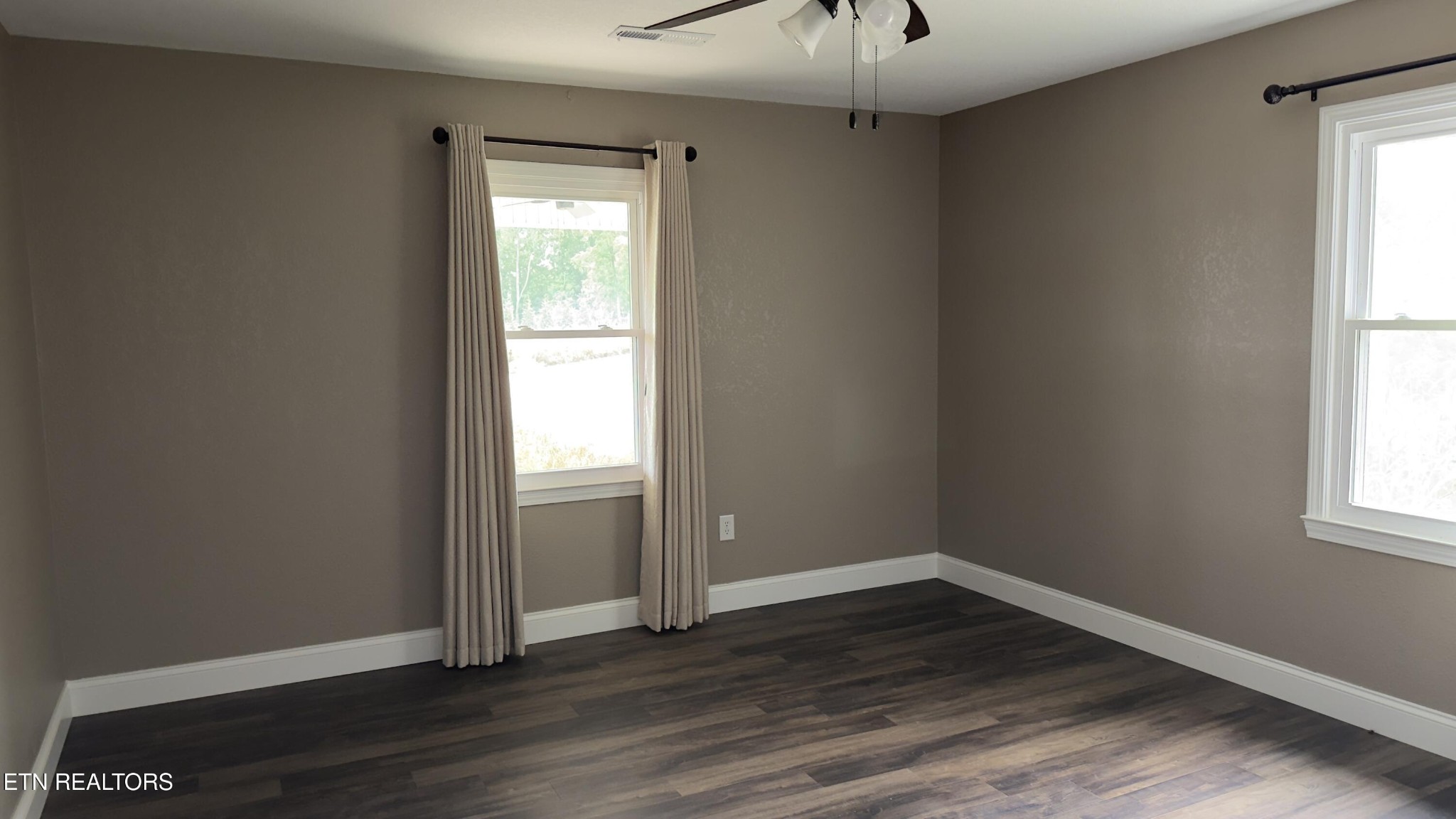 2662 Louisville Road Maryville, TN 37801 - Photo 13 of 60 an empty room with wooden floor and windows