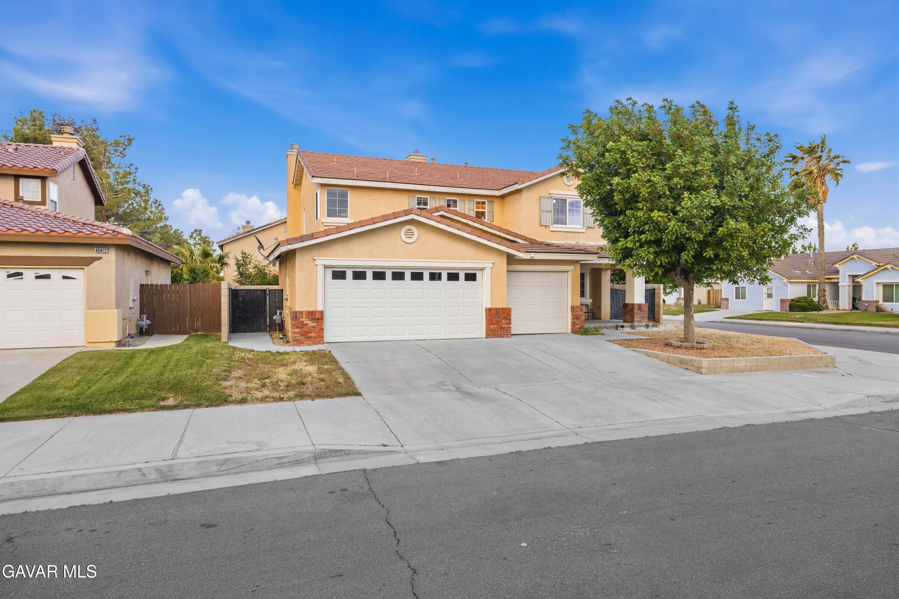 43406 Rucker Street Lancaster, CA 93535 - Photo 6 of 45 a front view of a house with a yard
