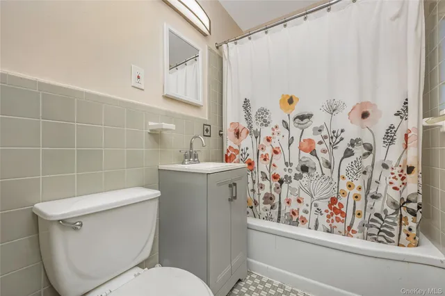 a white toilet sitting next to a bathroom sink