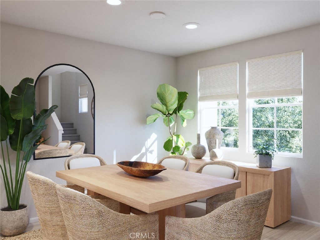 28058 Melrose Drive Temecula, CA 92591 - Photo 8 of 20 a dining room with furniture a potted plant and a wooden floor