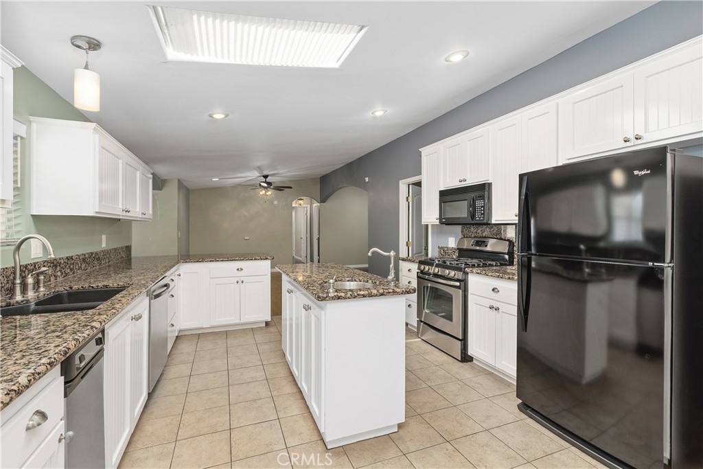 23742 Bundy Canyon Road Wildomar, CA 92595 - Photo 11 of 38 a kitchen with a sink stainless steel appliances and cabinets