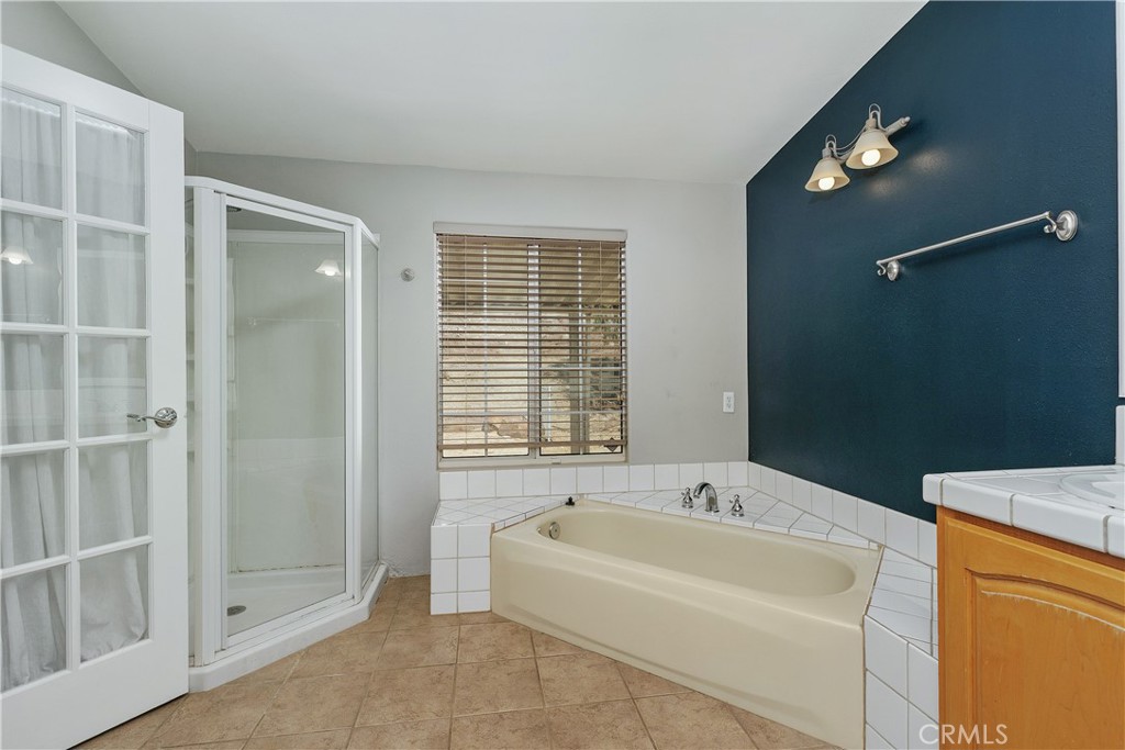 23742 Bundy Canyon Road Wildomar, CA 92595 - Photo 15 of 38 a spacious bathroom with bathtub and shower