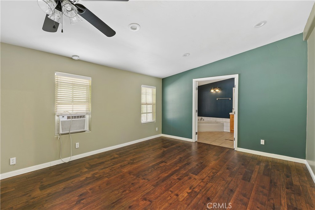 23742 Bundy Canyon Road Wildomar, CA 92595 - Photo 16 of 38 a view of an empty room with a window and wooden floor