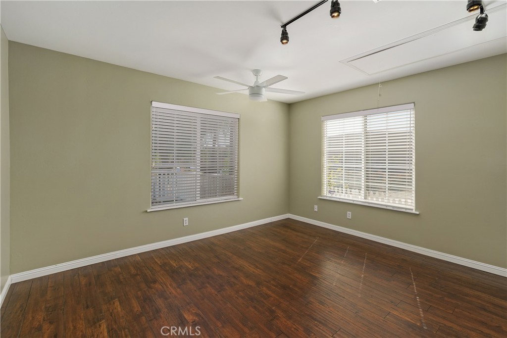 23742 Bundy Canyon Road Wildomar, CA 92595 - Photo 20 of 38 a view of an empty room with a window and wooden floor