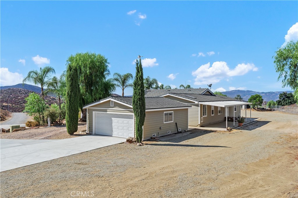 23742 Bundy Canyon Road Wildomar, CA 92595 - Photo 29 of 38 a view of a house with a sink and a yard