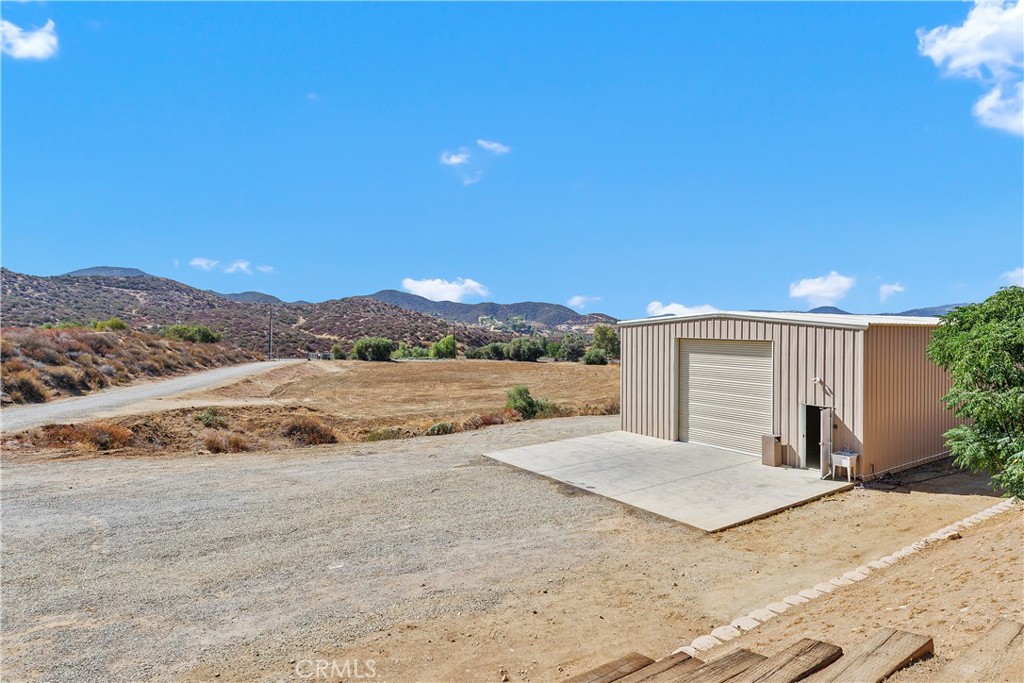 23742 Bundy Canyon Road Wildomar, CA 92595 - Photo 31 of 38 a view of a house with a yard and large tree