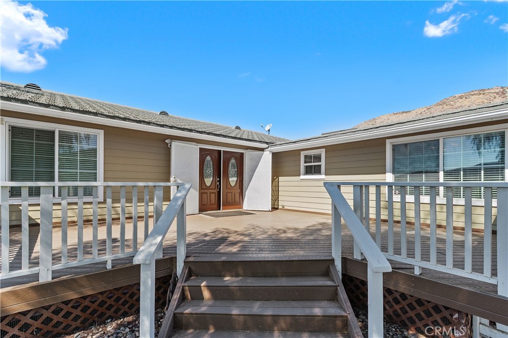 23742 Bundy Canyon Road Wildomar, CA 92595 - Photo 4 of 38 a front view of a house with two windows