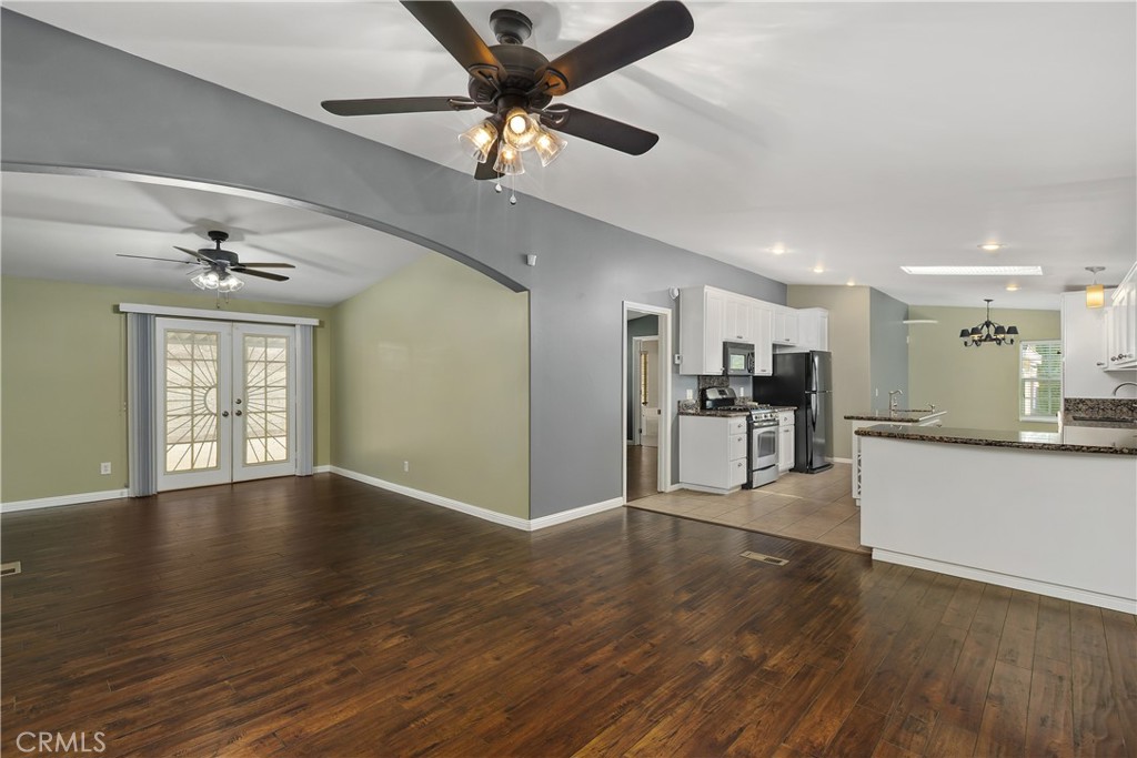 23742 Bundy Canyon Road Wildomar, CA 92595 - Photo 9 of 38 a view of an empty room and kitchen with wooden floor