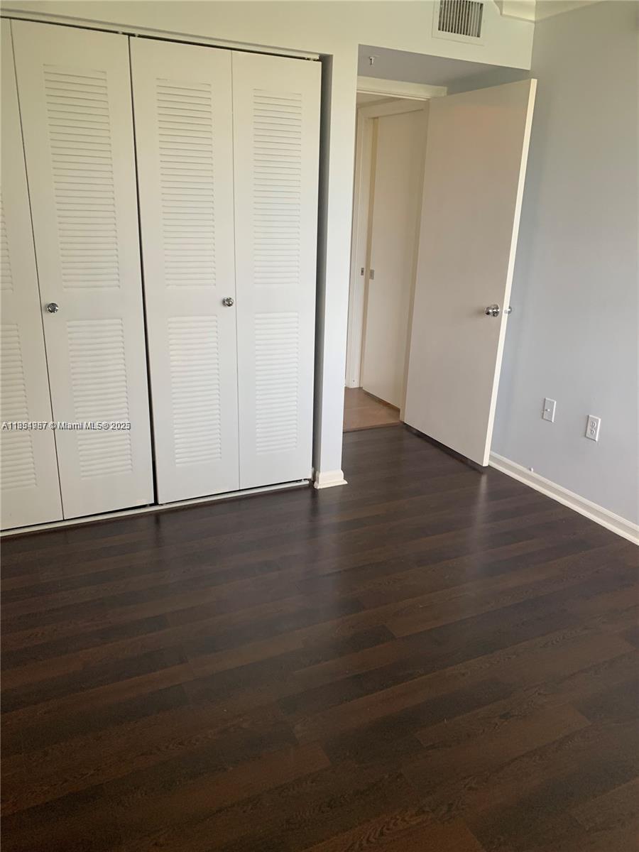 2071 Renaissance Boulevard, Unit 108 Miramar, FL 33025 - Photo 12 of 25 an empty room with wooden floor