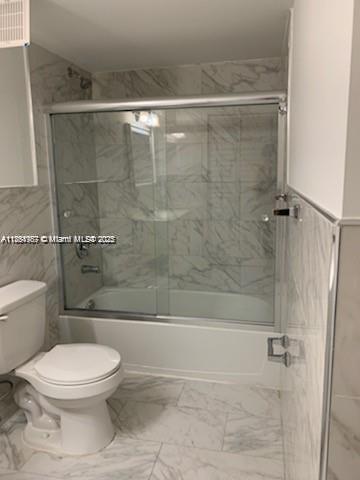 2071 Renaissance Boulevard, Unit 108 Miramar, FL 33025 - Photo 17 of 25 a bathroom with a toilet and a shower