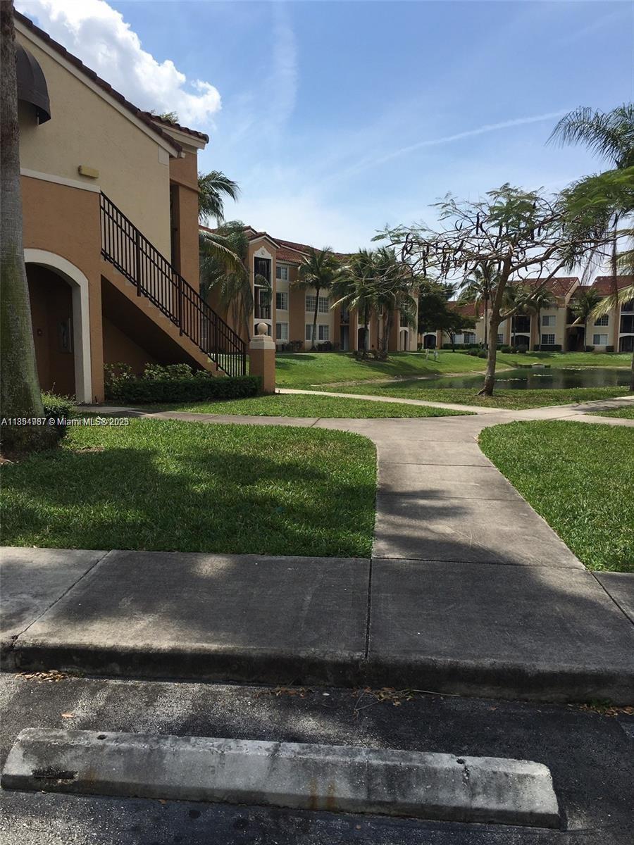 2071 Renaissance Boulevard, Unit 108 Miramar, FL 33025 - Photo 20 of 25 a view of a house with a yard