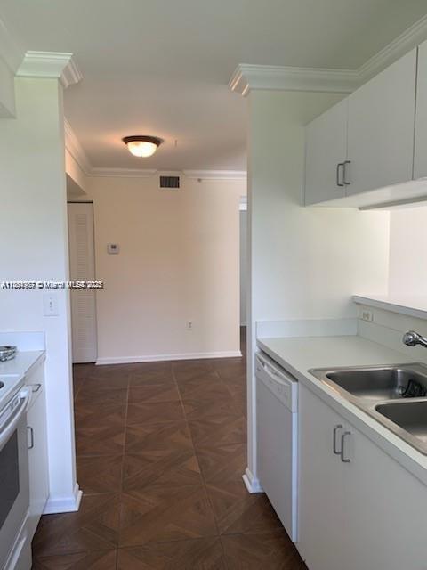2071 Renaissance Boulevard, Unit 108 Miramar, FL 33025 - Photo 8 of 25 a kitchen that has a sink and a stove