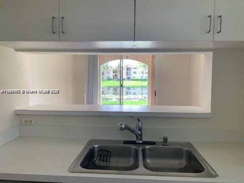 2071 Renaissance Boulevard, Unit 108 Miramar, FL 33025 - Photo 9 of 25 a kitchen with a sink and a window