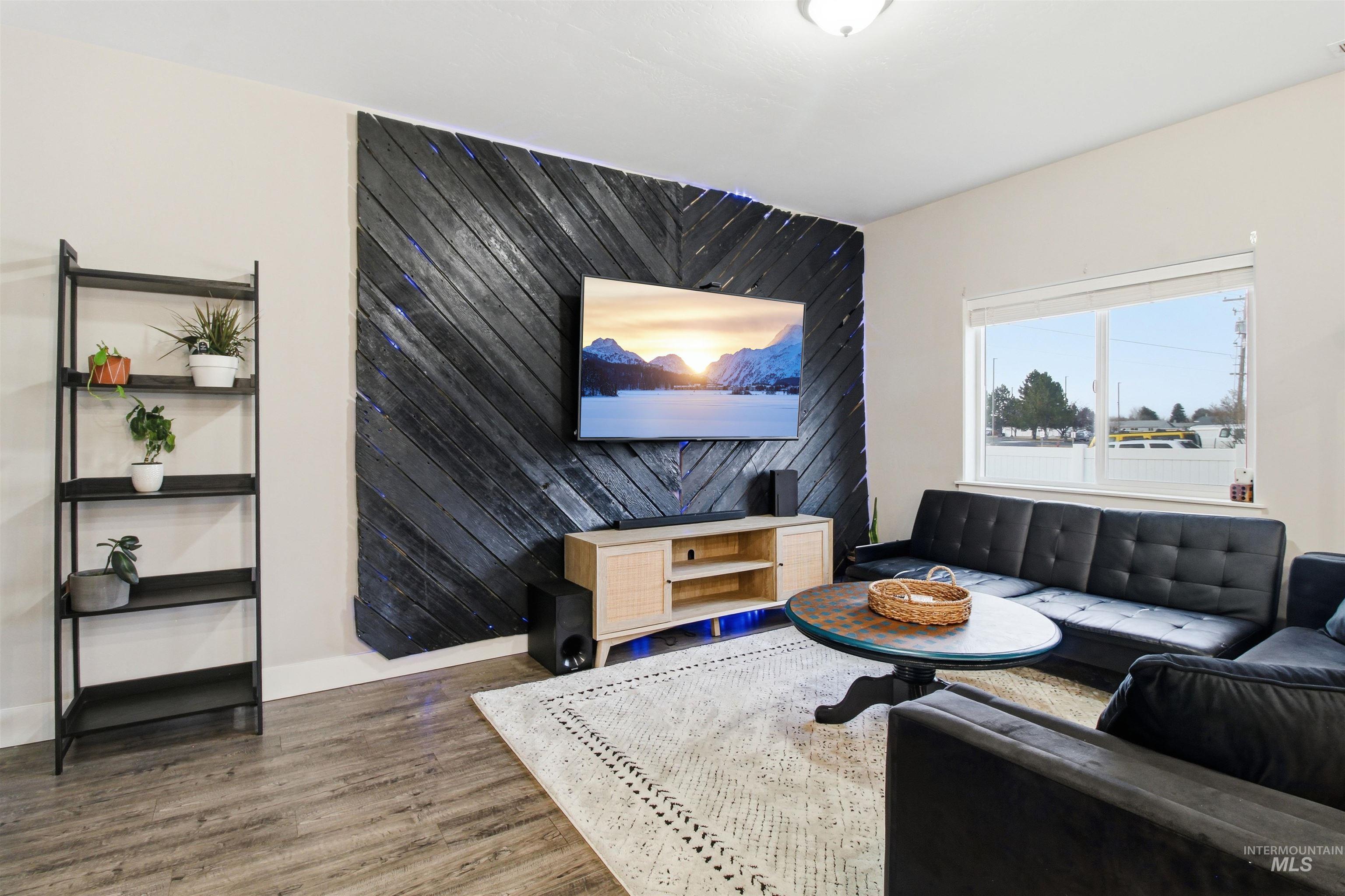 900 East 20th Street Burley, ID 83318 - Photo 11 of 31 Living room with wood finished floors and an accent wall