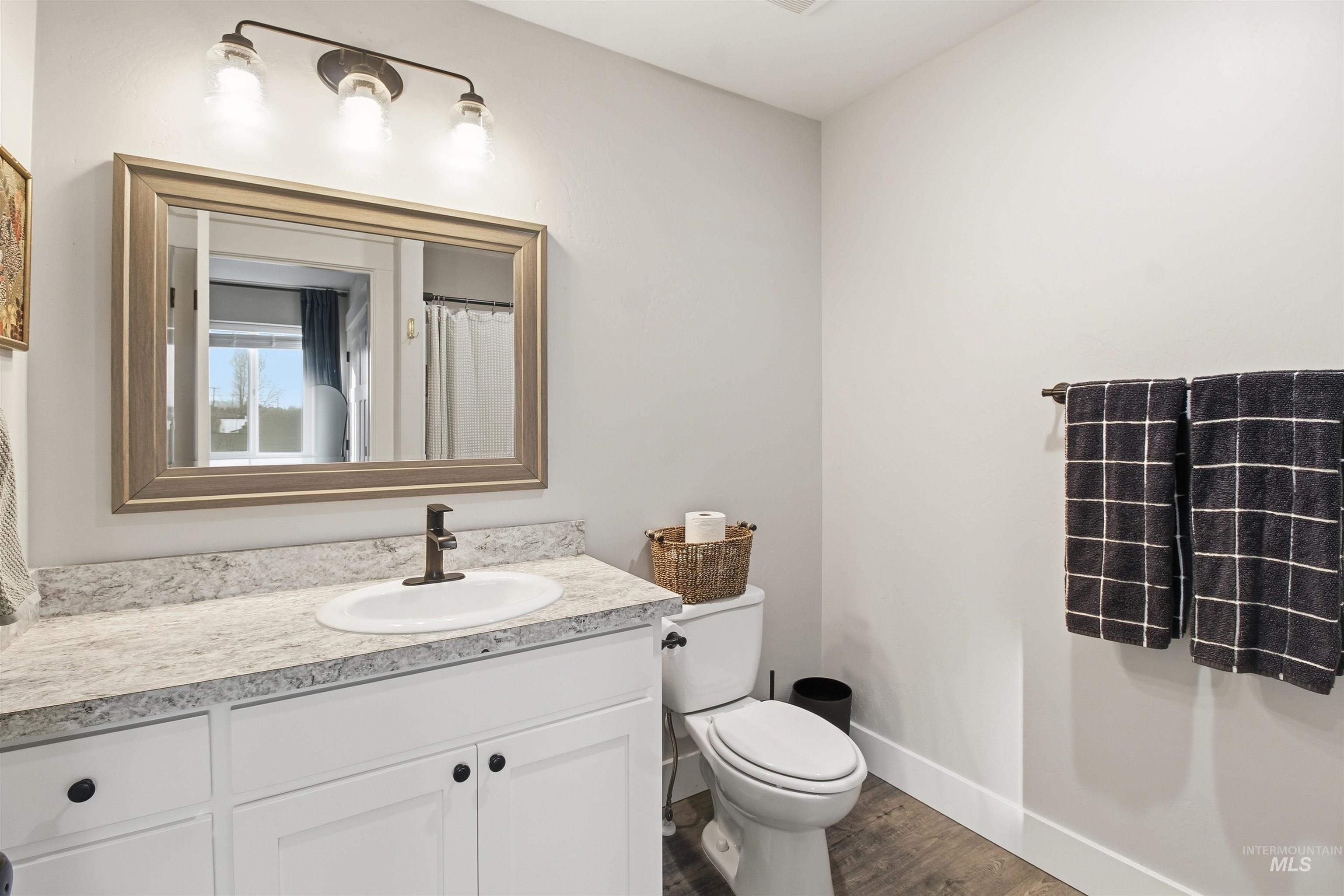 900 East 20th Street Burley, ID 83318 - Photo 20 of 31 Bathroom featuring a shower with shower curtain, vanity, and dark wood-style flooring
