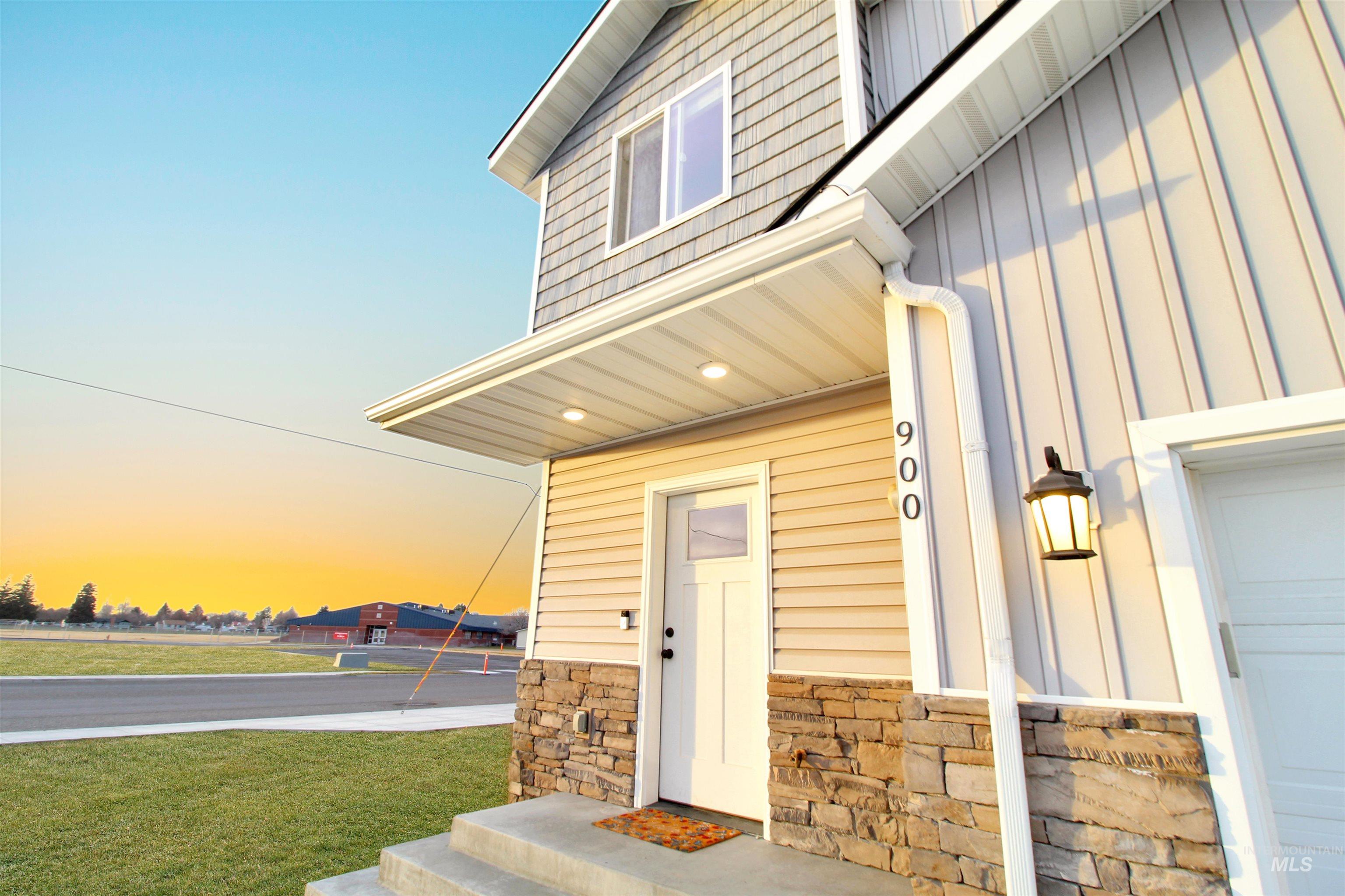 900 East 20th Street Burley, ID 83318 - Photo 2 of 31 Property entrance featuring a garage, board and batten siding, a lawn, and stone siding