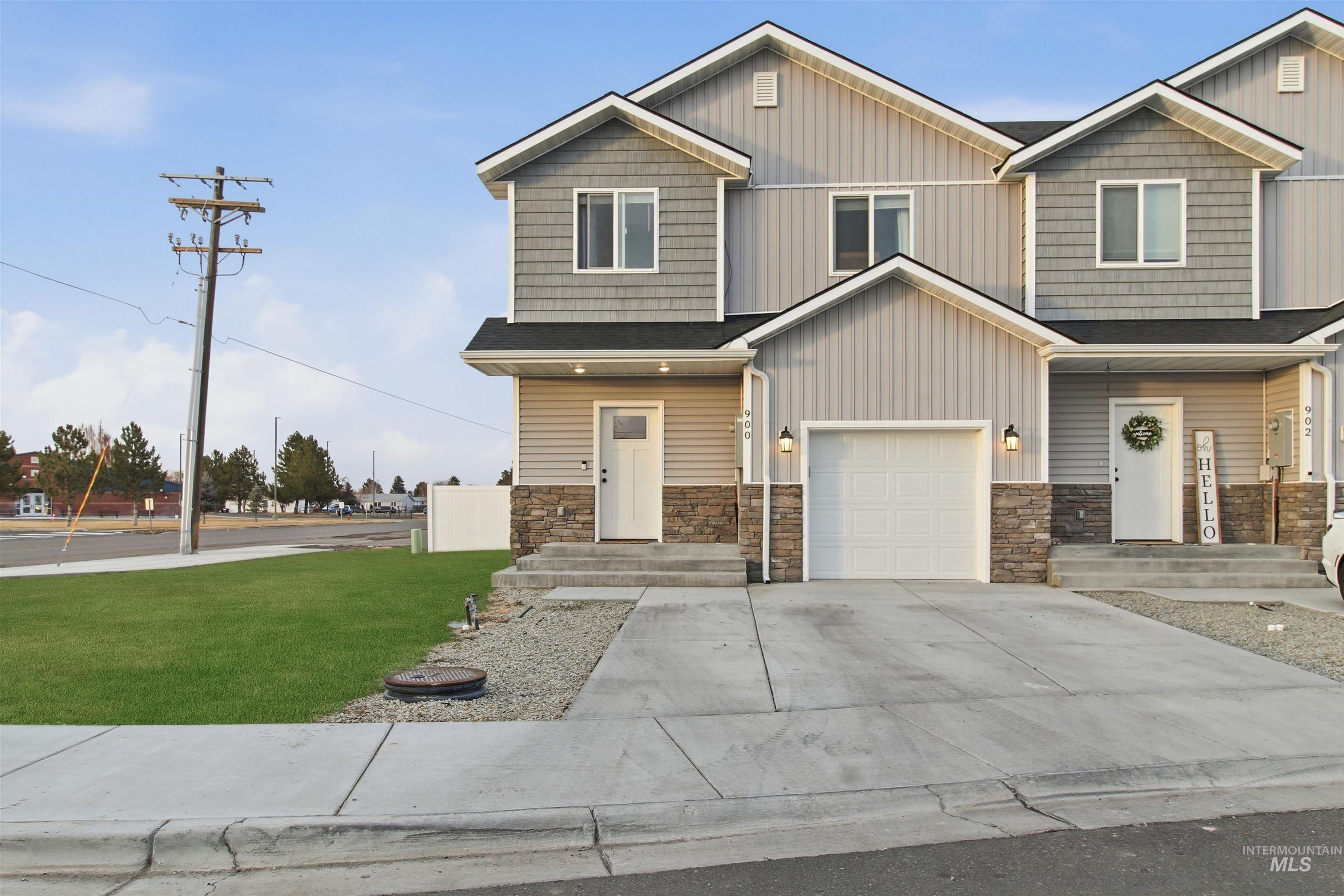 900 East 20th Street Burley, ID 83318 - Photo 29 of 31 Craftsman inspired home with stone siding, a front lawn, an attached garage, concrete driveway, and board and batten siding