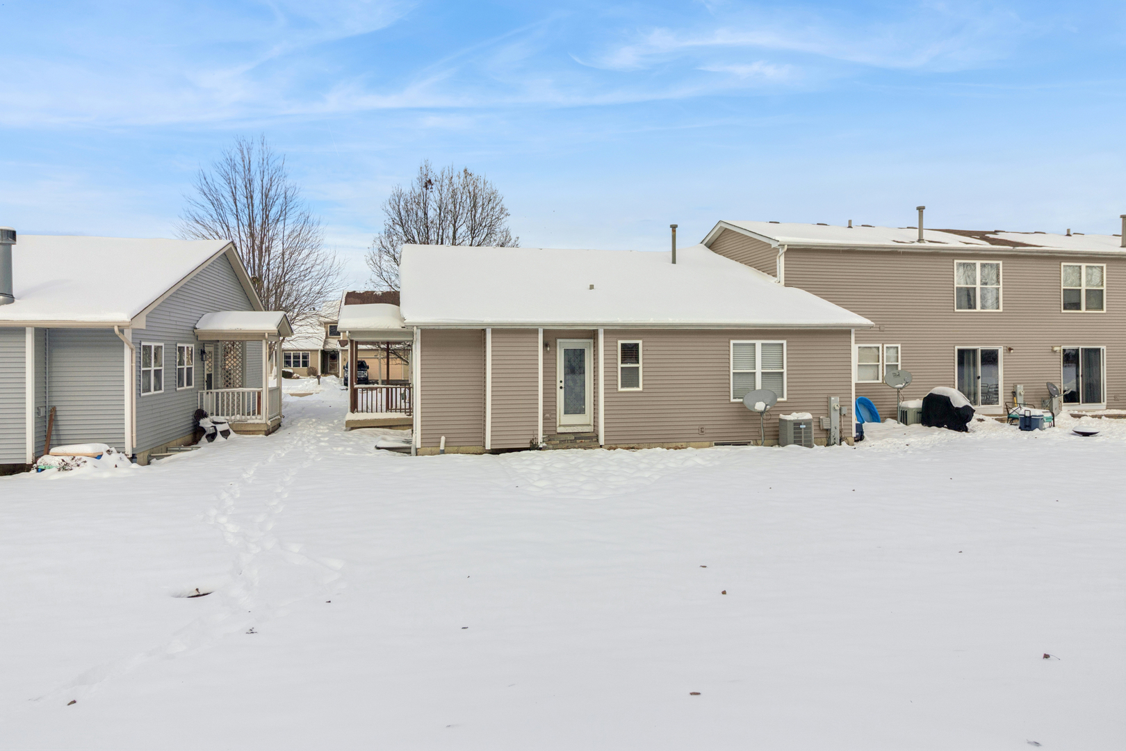 225 Morrow Street, Unit D Somonauk, IL 60552 - Photo 19 of 19 a front view of a house with a yard and garage