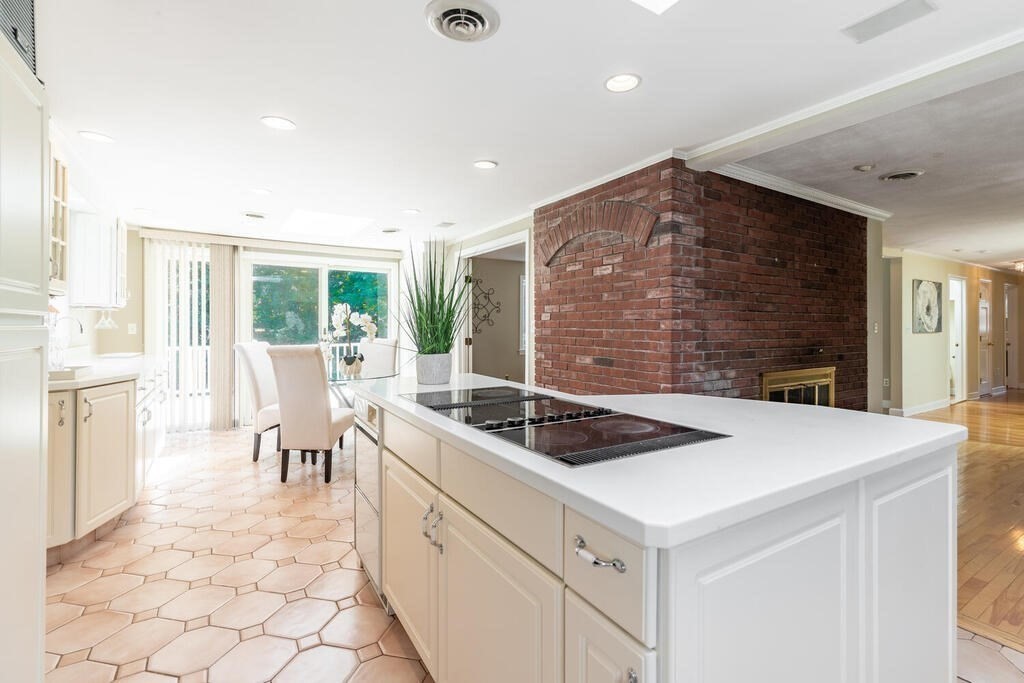 44 Philip Road Lexington, MA 02421 - Photo 11 of 31 a kitchen that has a stove a table and chairs in it