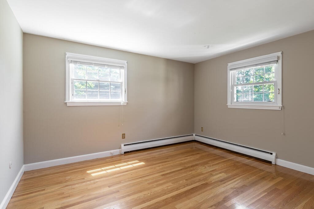 44 Philip Road Lexington, MA 02421 - Photo 20 of 31 a view of an empty room with wooden floor and a window