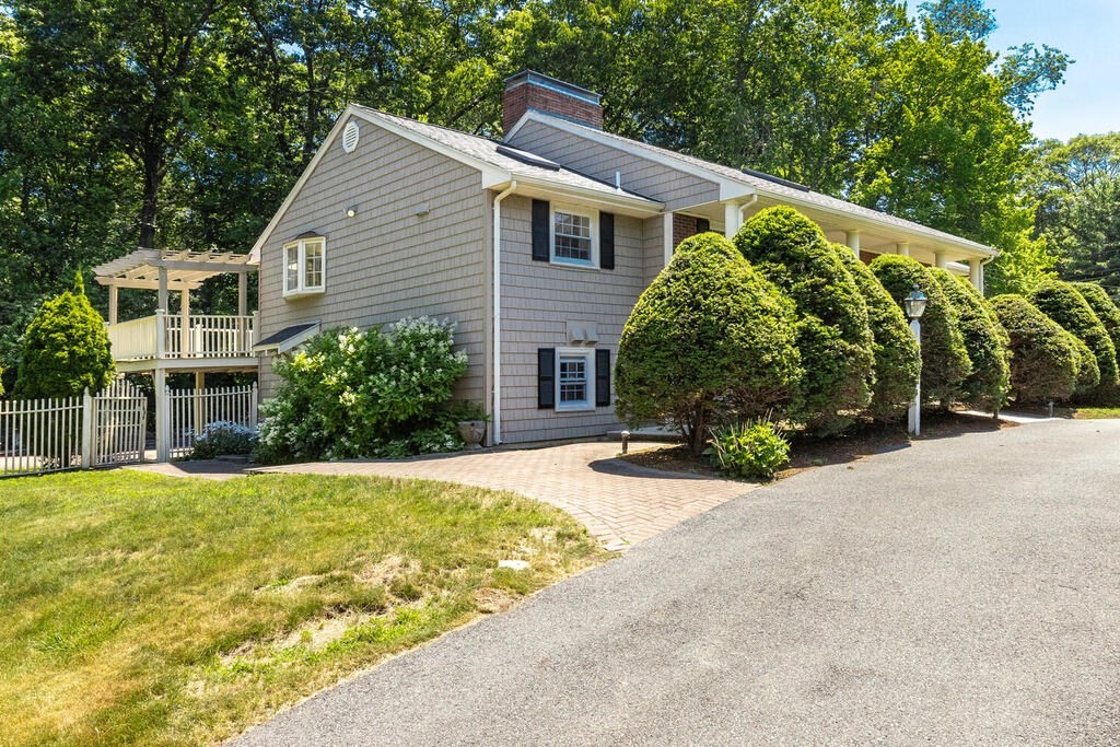44 Philip Road Lexington, MA 02421 - Photo 3 of 31 a front view of a house with a yard and garage
