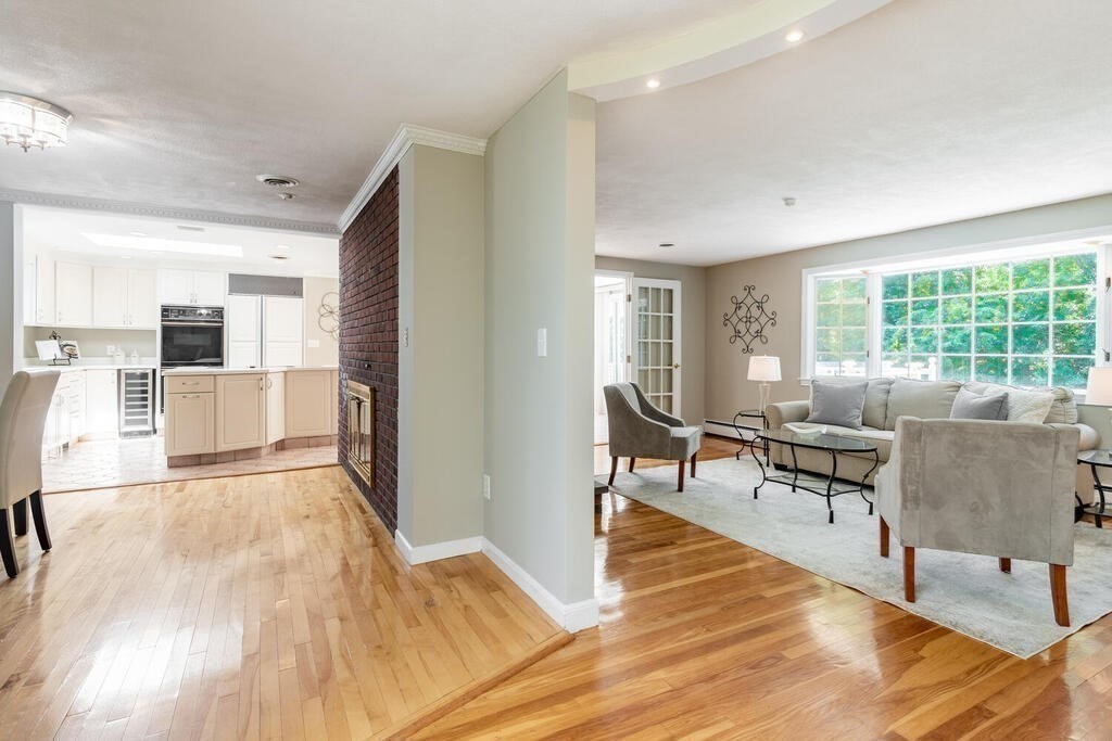 44 Philip Road Lexington, MA 02421 - Photo 7 of 31 a living room with furniture and large windows