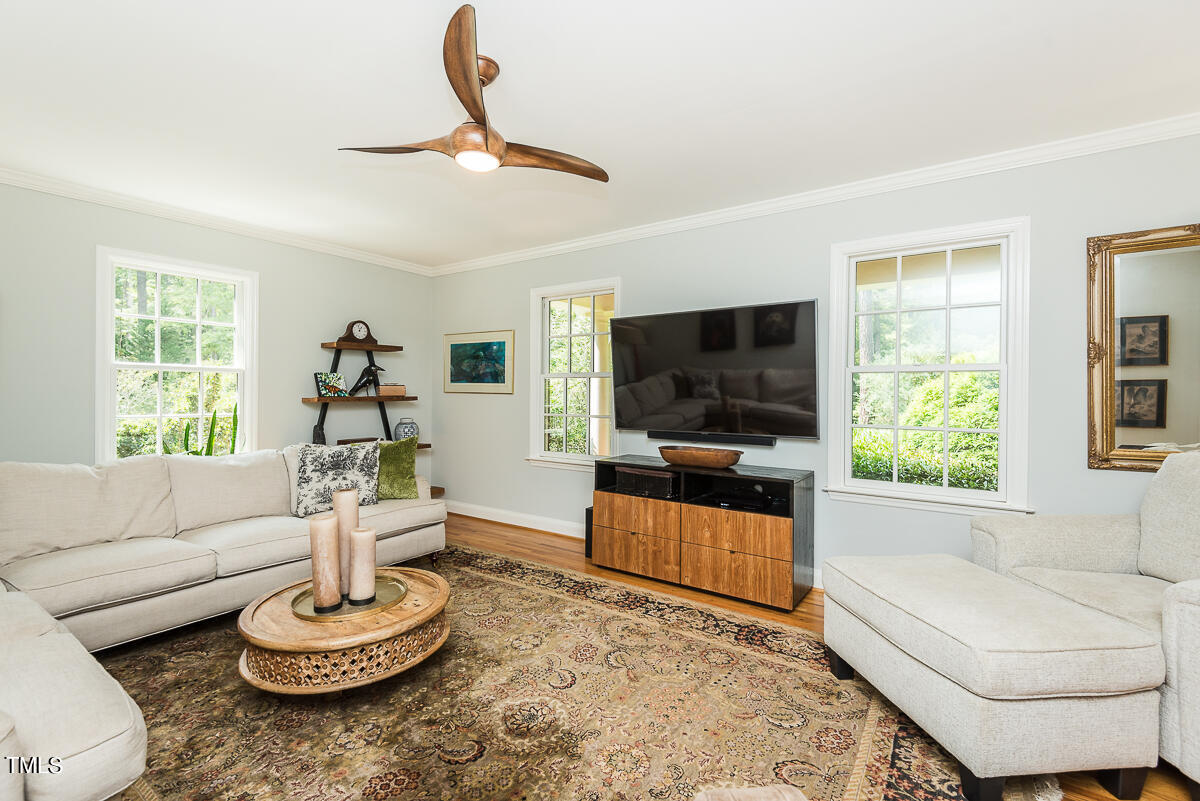 7214 Sunrise Road Chapel Hill, NC 27514 - Photo 14 of 61 a living room with furniture a window and a flat screen tv