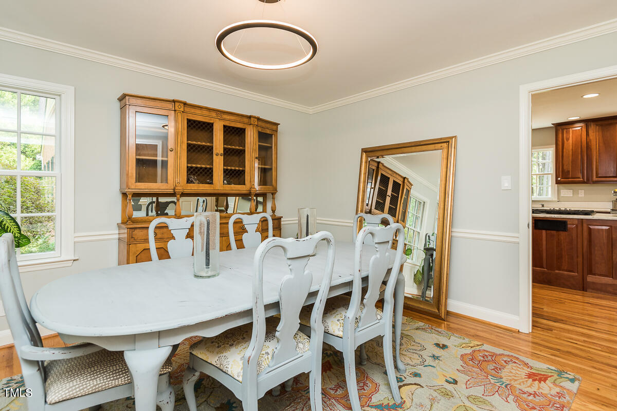 7214 Sunrise Road Chapel Hill, NC 27514 - Photo 15 of 61 a view of a dining room with furniture and wooden floor