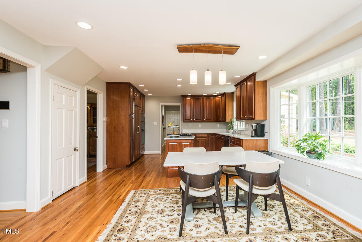 7214 Sunrise Road Chapel Hill, NC 27514 - Photo 21 of 61 a view of a dining room with furniture window and wooden floor