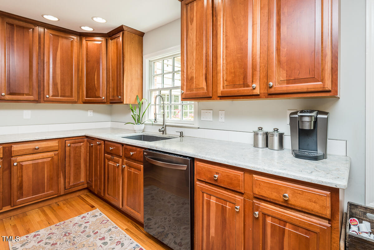 7214 Sunrise Road Chapel Hill, NC 27514 - Photo 23 of 61 a kitchen with stainless steel appliances granite countertop wooden cabinets a sink and dishwasher