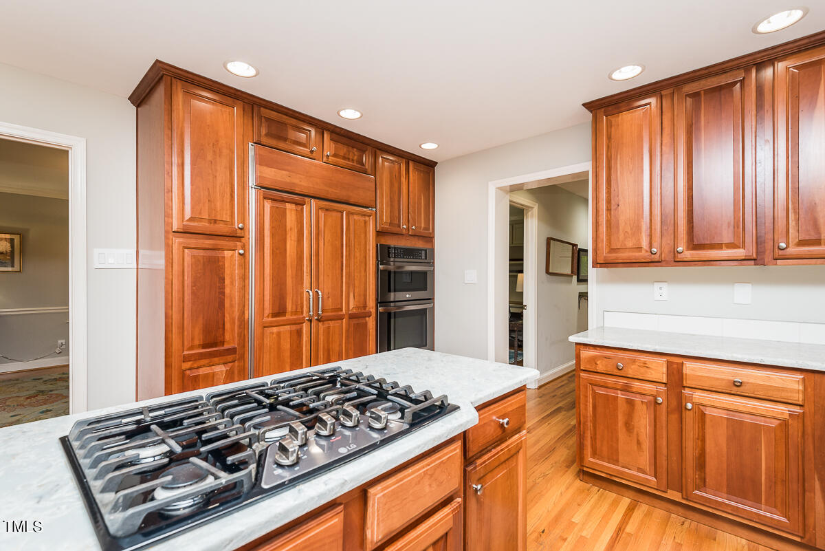 7214 Sunrise Road Chapel Hill, NC 27514 - Photo 24 of 61 a kitchen with stainless steel appliances granite countertop a refrigerator and a stove top oven