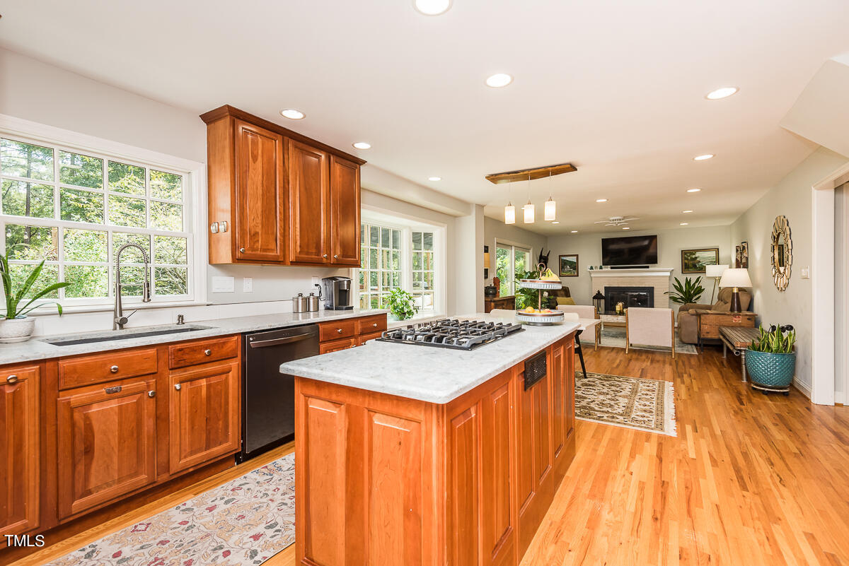 7214 Sunrise Road Chapel Hill, NC 27514 - Photo 25 of 61 a kitchen with stainless steel appliances granite countertop wooden cabinets a sink and a stove