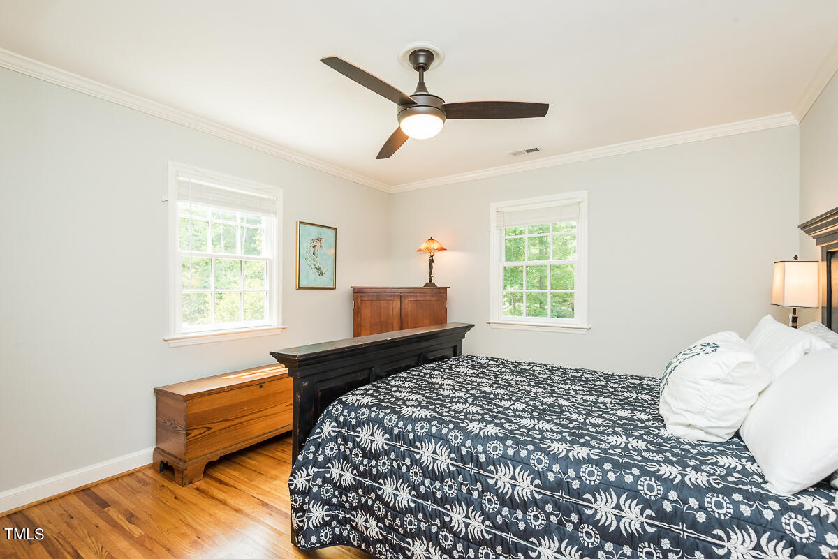 7214 Sunrise Road Chapel Hill, NC 27514 - Photo 35 of 61 a bedroom with a bed and wooden floor