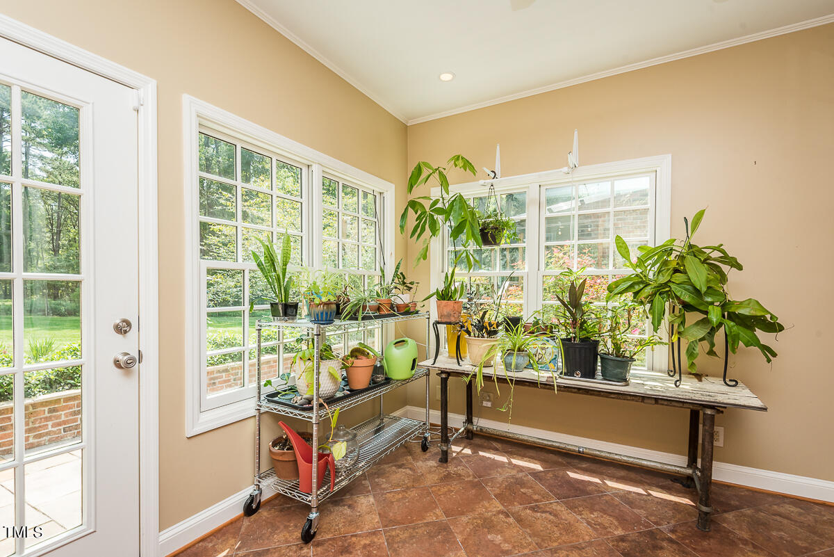 7214 Sunrise Road Chapel Hill, NC 27514 - Photo 38 of 61 a living room filled with furniture and a potted plant