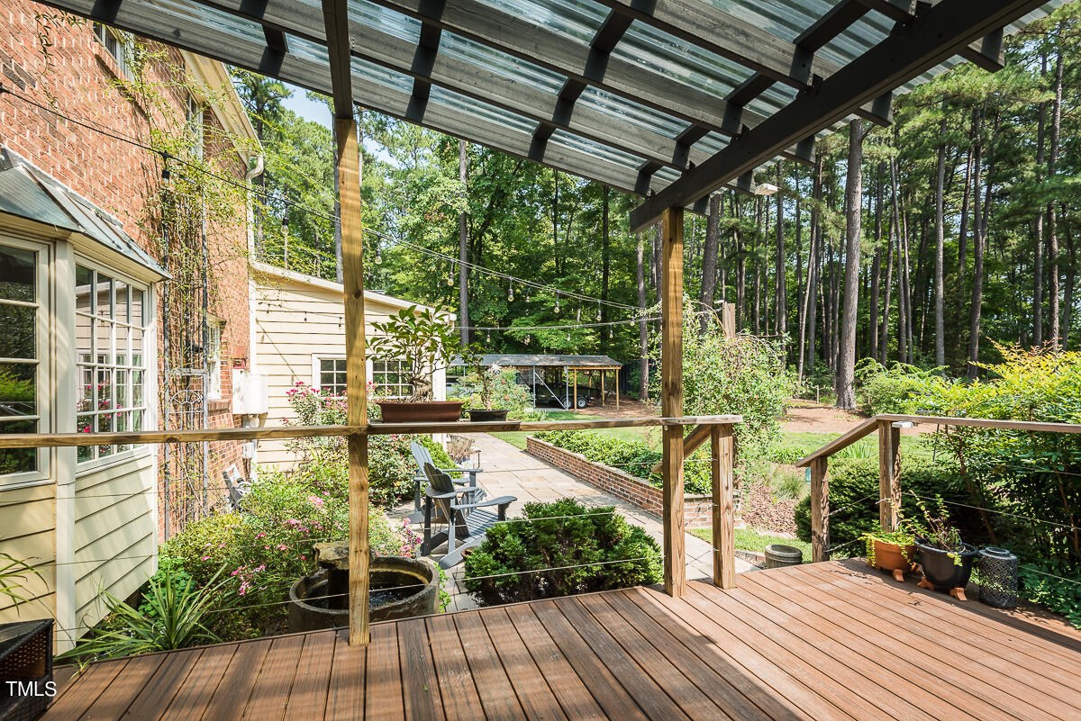 7214 Sunrise Road Chapel Hill, NC 27514 - Photo 40 of 61 a view of a balcony with chairs and wooden floor