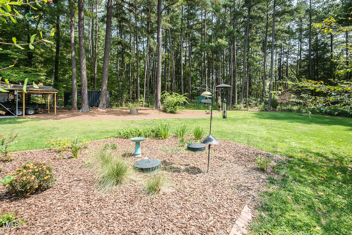 7214 Sunrise Road Chapel Hill, NC 27514 - Photo 42 of 61 a wooden bench sitting in the middle of a park